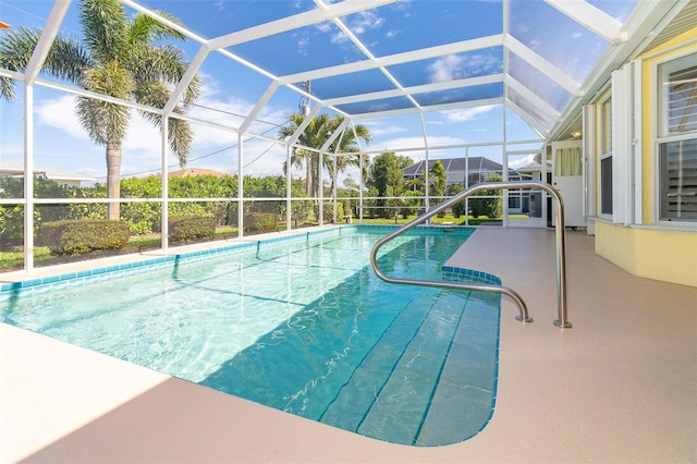 view of pool with a patio and glass enclosure