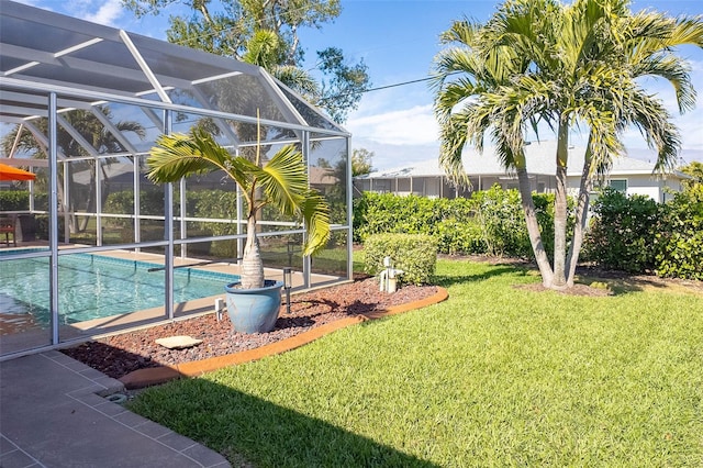 view of pool featuring glass enclosure and a lawn