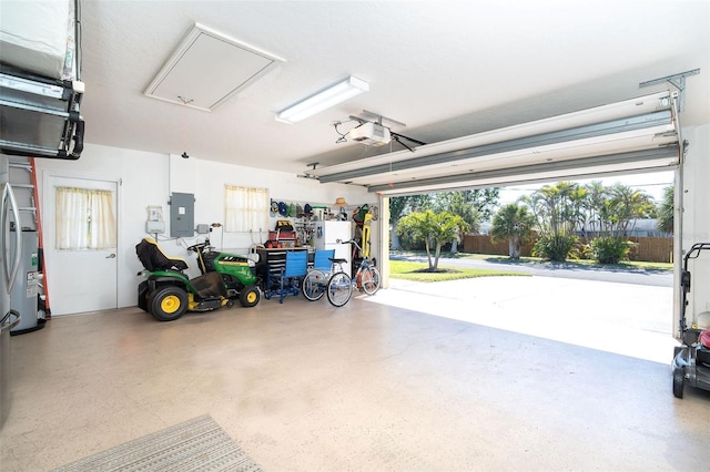 garage with a garage door opener and electric panel