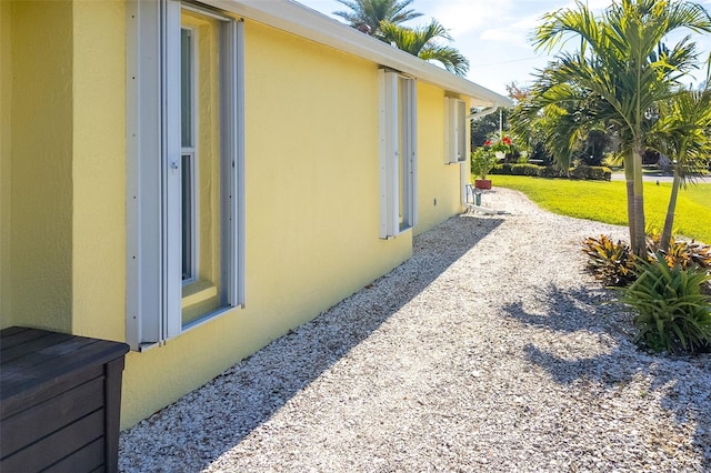 view of side of home featuring a lawn