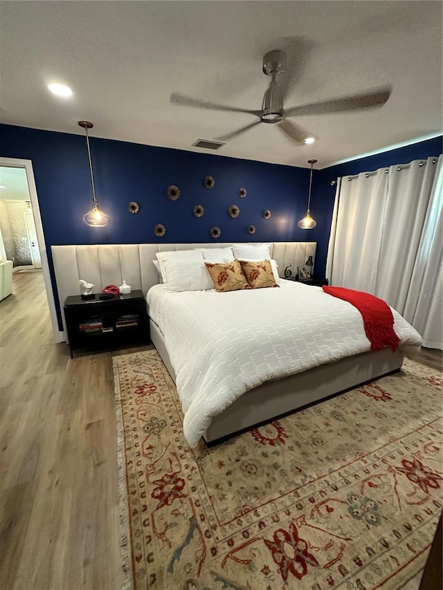 bedroom with hardwood / wood-style flooring and ceiling fan