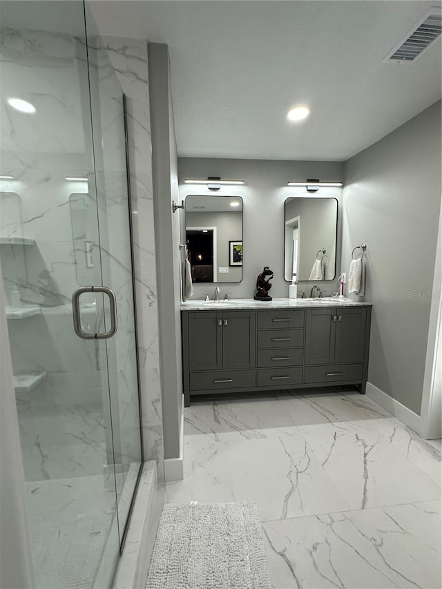 bathroom with a shower with door and vanity