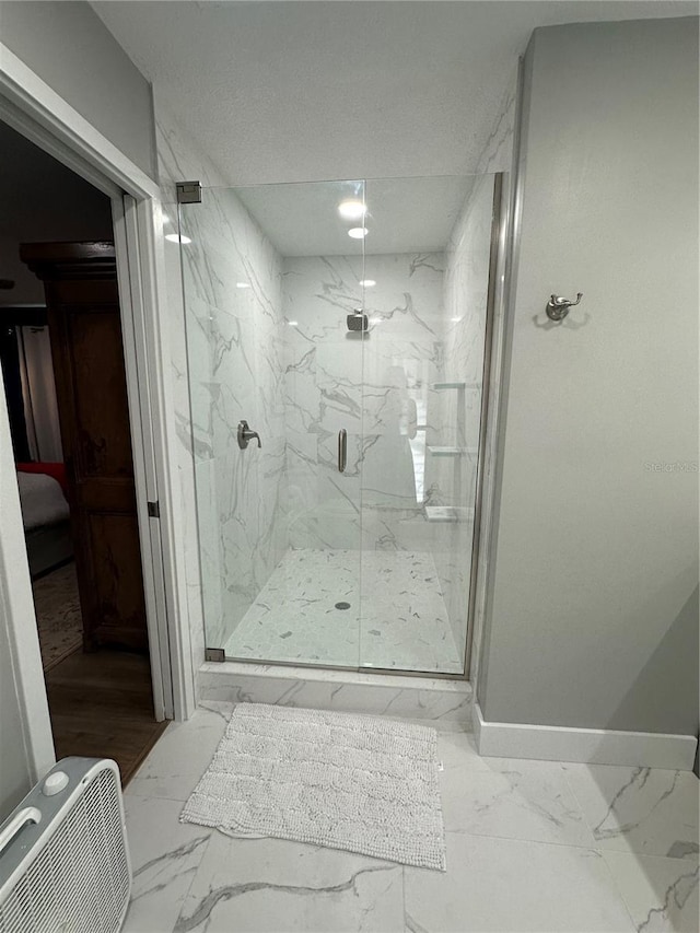 bathroom featuring a shower with door