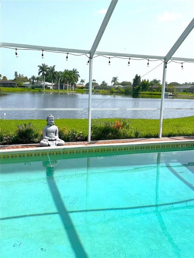 view of pool featuring a water view and a lanai