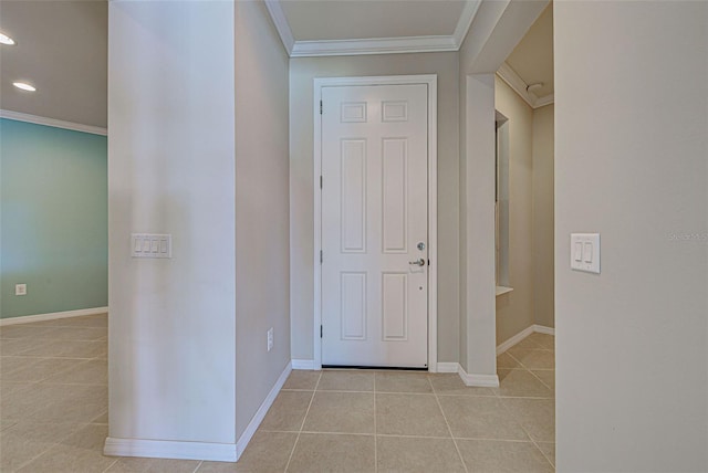 tiled entryway featuring ornamental molding