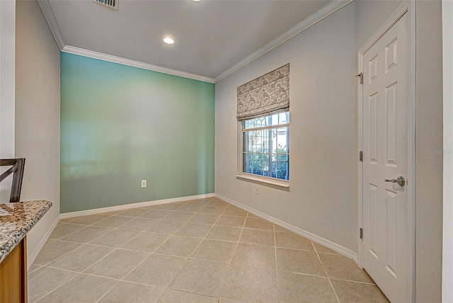 unfurnished room with crown molding and light tile patterned floors