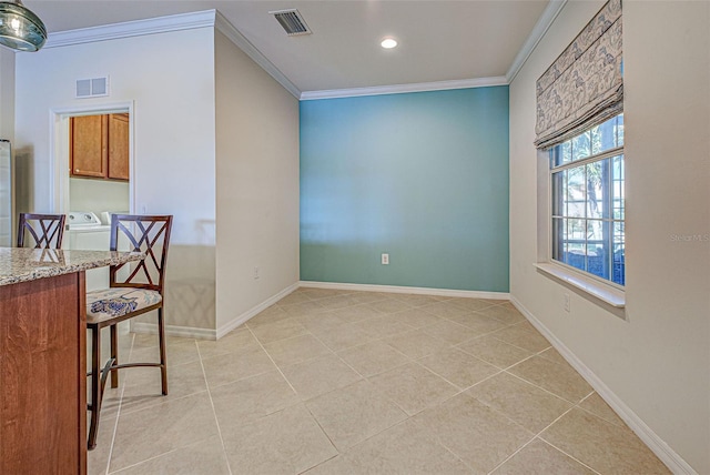 tiled dining area featuring ornamental molding