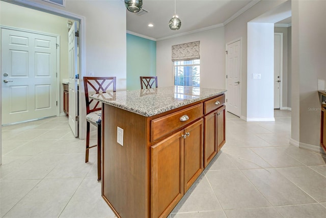 kitchen featuring pendant lighting, light tile patterned floors, crown molding, a center island, and light stone countertops