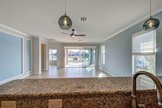 kitchen with ornamental molding, sink, light tile patterned floors, and ceiling fan