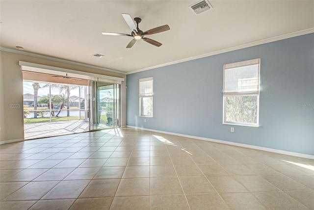 tiled empty room featuring ceiling fan and ornamental molding