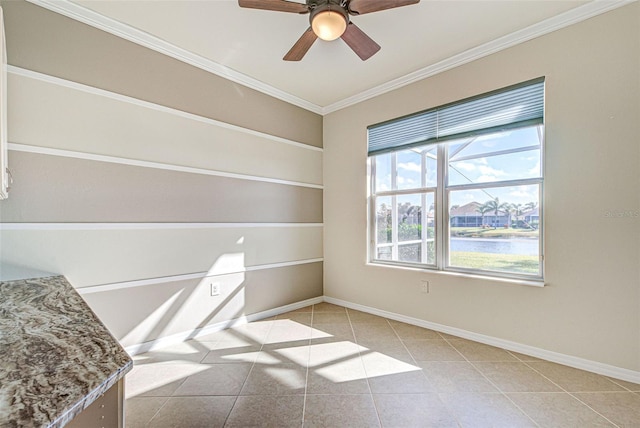 spare room with ornamental molding, light tile patterned floors, ceiling fan, a water view, and built in shelves