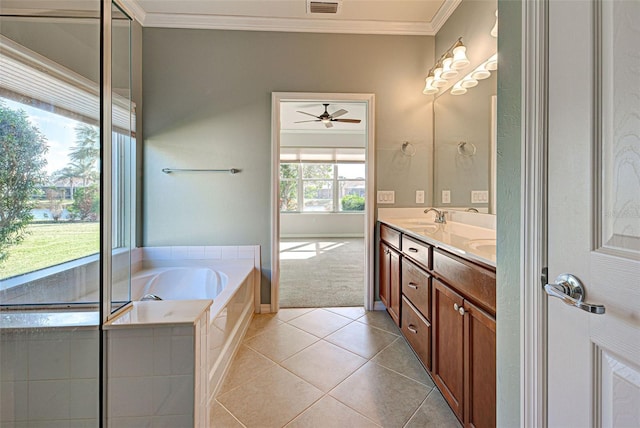 bathroom featuring crown molding, vanity, a bathing tub, ceiling fan, and tile patterned flooring