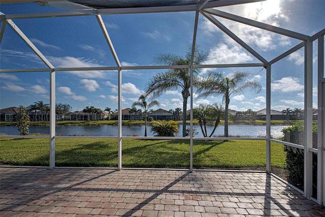 unfurnished sunroom with a water view