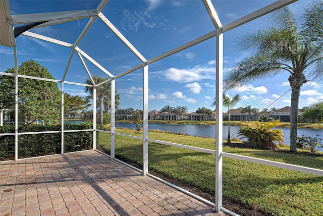 unfurnished sunroom featuring a water view