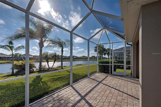 unfurnished sunroom with a water view