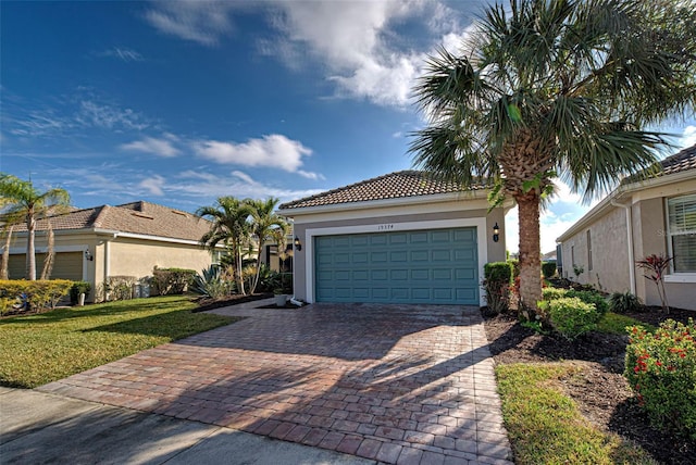 mediterranean / spanish-style home with a garage and a front yard