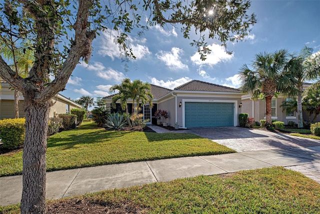 view of front of house with a garage and a front yard