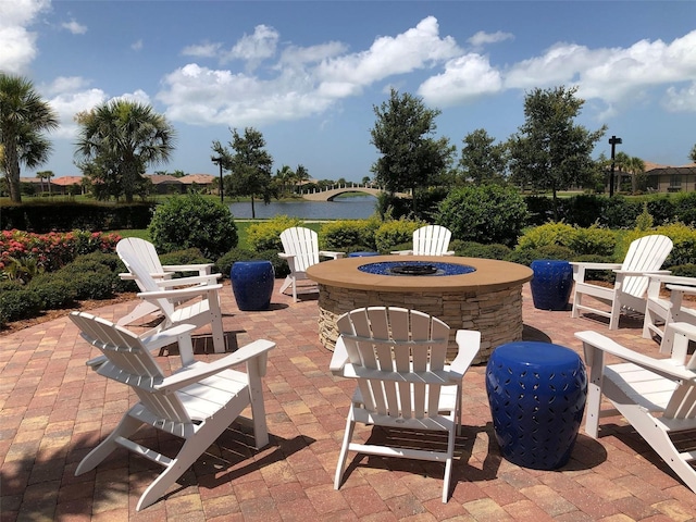 view of patio / terrace featuring a water view and an outdoor fire pit