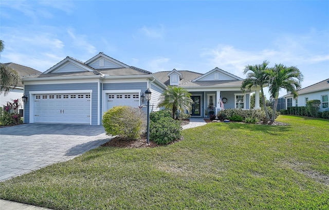 ranch-style home with a garage and a front lawn