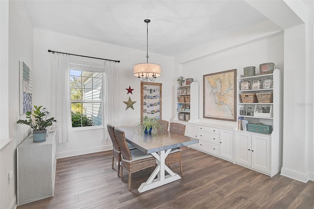 dining area with a notable chandelier and dark hardwood / wood-style floors