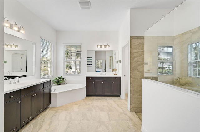 bathroom with vanity and independent shower and bath