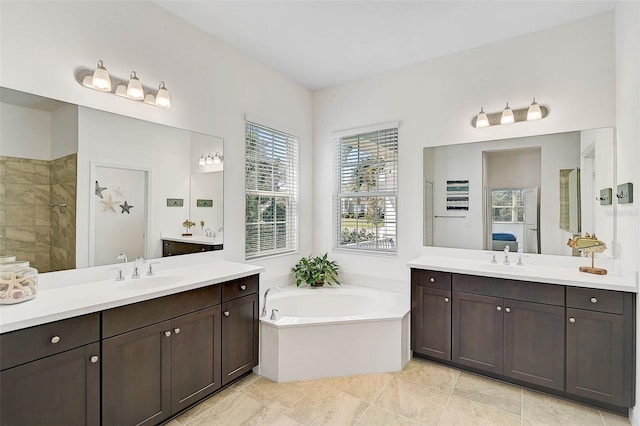 bathroom featuring vanity and separate shower and tub