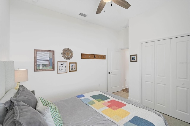 bedroom featuring a towering ceiling, ceiling fan, and a closet