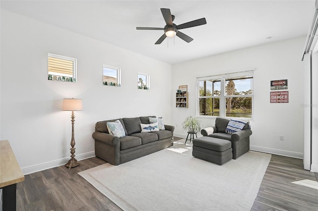 living room featuring dark hardwood / wood-style flooring and ceiling fan