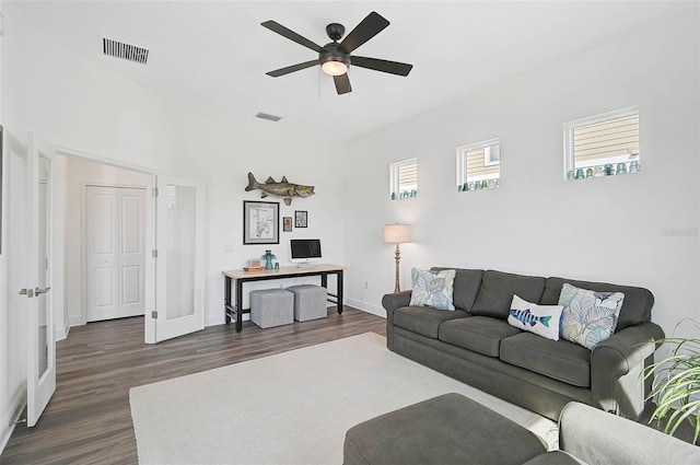 living room featuring dark hardwood / wood-style flooring and ceiling fan