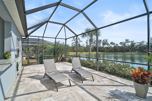 view of patio featuring a water view and a lanai