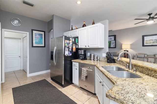 kitchen featuring sink, light stone countertops, white cabinets, and appliances with stainless steel finishes