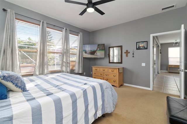 bedroom featuring ceiling fan and light colored carpet