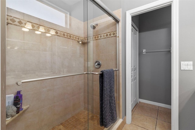 bathroom with tile patterned floors and walk in shower