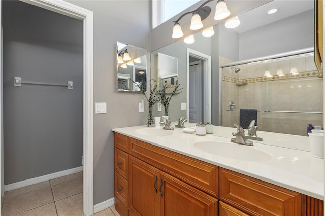 bathroom featuring vanity, tile patterned flooring, and a tile shower