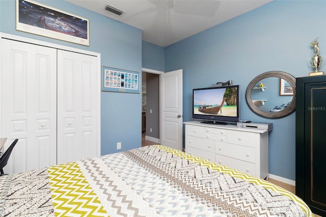 bedroom with ceiling fan and a closet