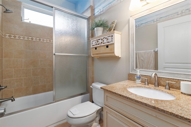 full bathroom with vanity, toilet, and combined bath / shower with glass door