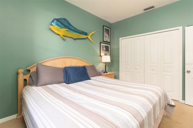 bedroom featuring light carpet and a closet