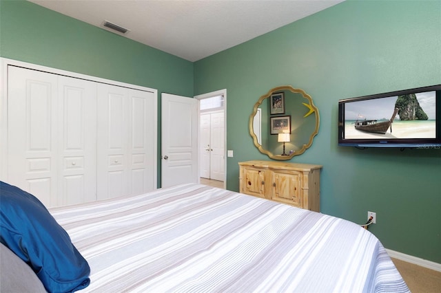 carpeted bedroom featuring a closet