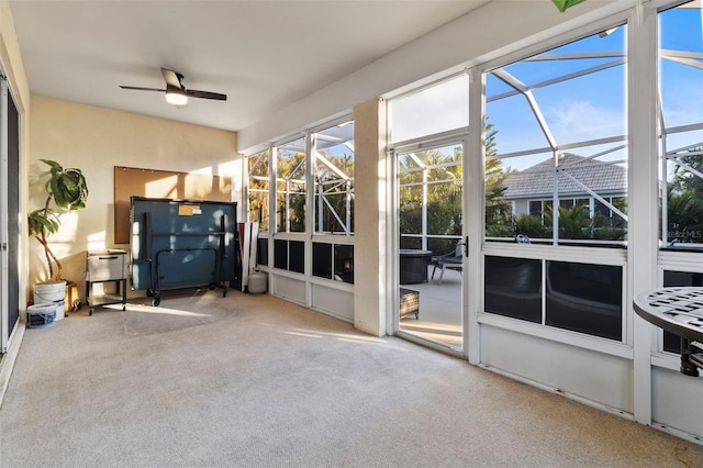 unfurnished sunroom with ceiling fan