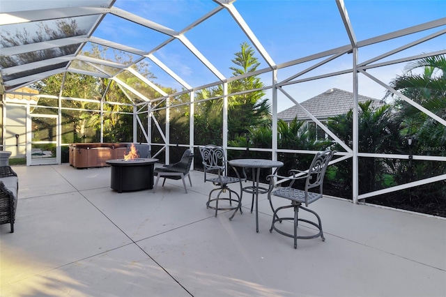 view of patio featuring a hot tub and glass enclosure