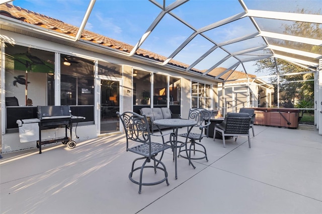 view of patio / terrace with a hot tub, a lanai, area for grilling, and an outdoor living space