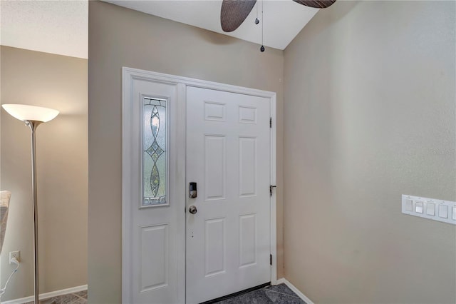 foyer entrance featuring ceiling fan and baseboards