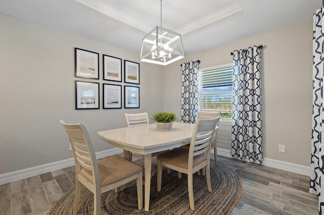 dining area featuring a tray ceiling and a notable chandelier