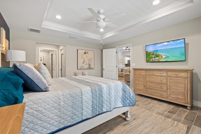 bedroom featuring a raised ceiling, crown molding, and ceiling fan