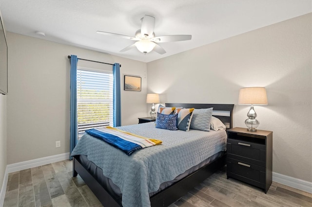 bedroom featuring ceiling fan and dark hardwood / wood-style flooring