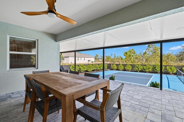 sunroom / solarium featuring ceiling fan