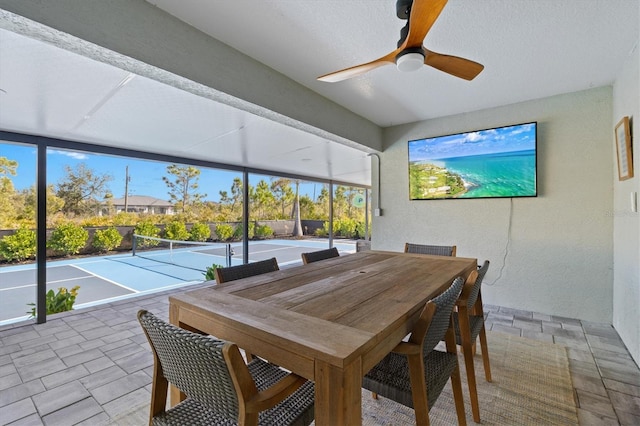 sunroom / solarium featuring ceiling fan