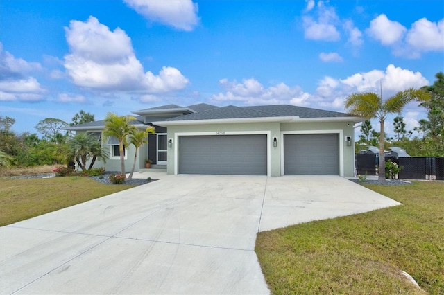 view of front of property with a garage and a front lawn