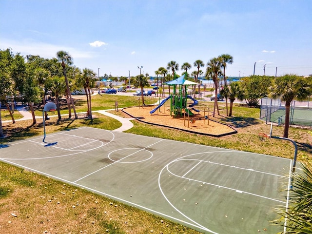 view of basketball court featuring a playground