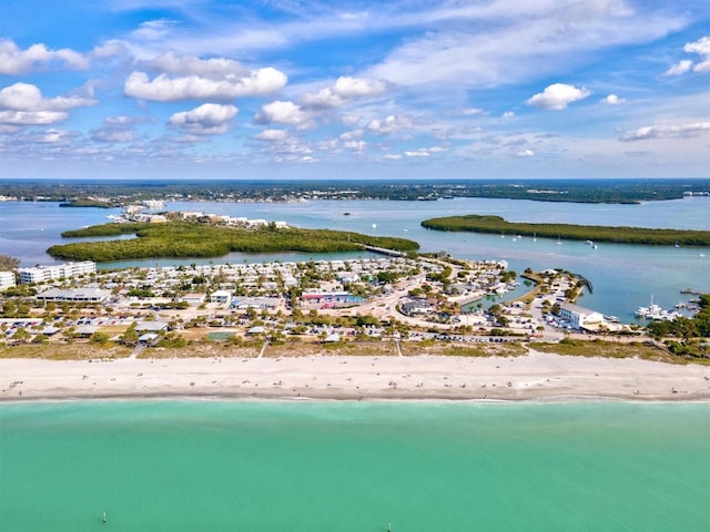 bird's eye view with a water view and a beach view